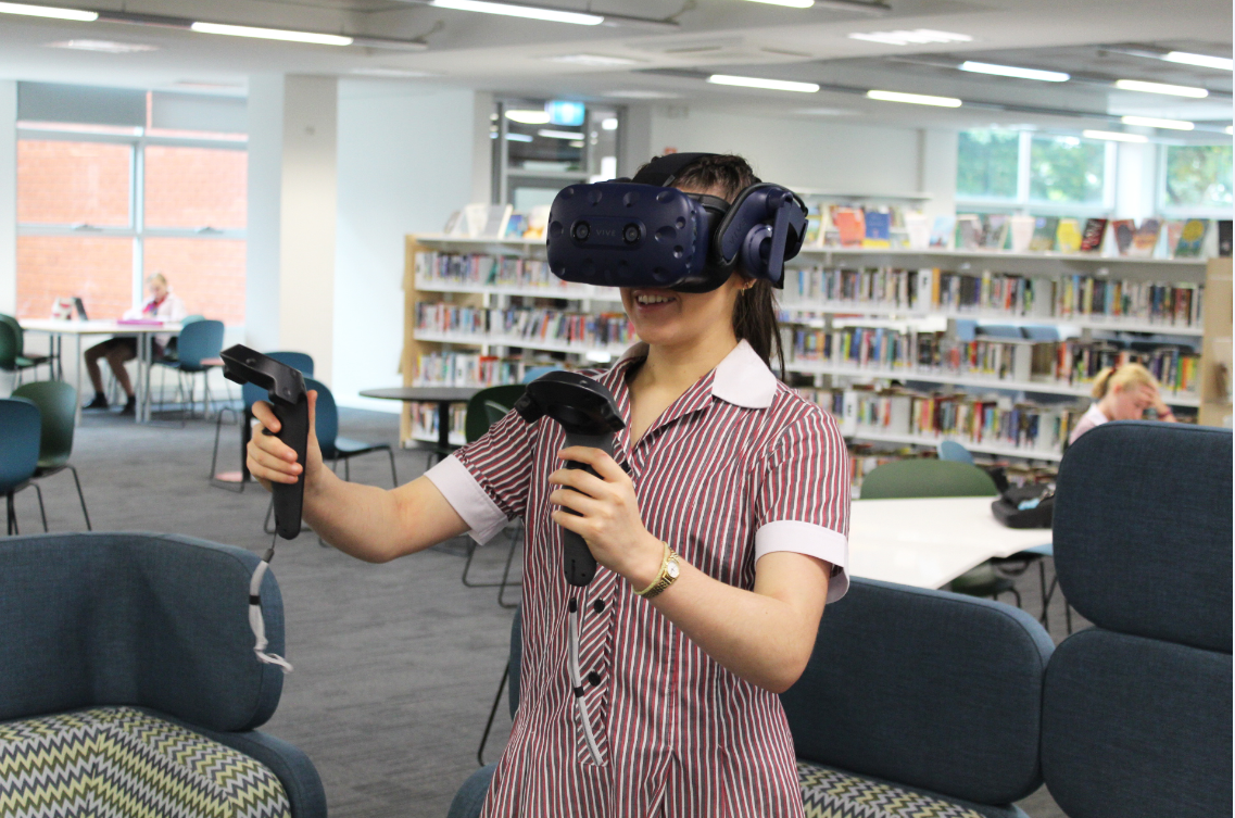 Image of a high school female student with a VR headset.