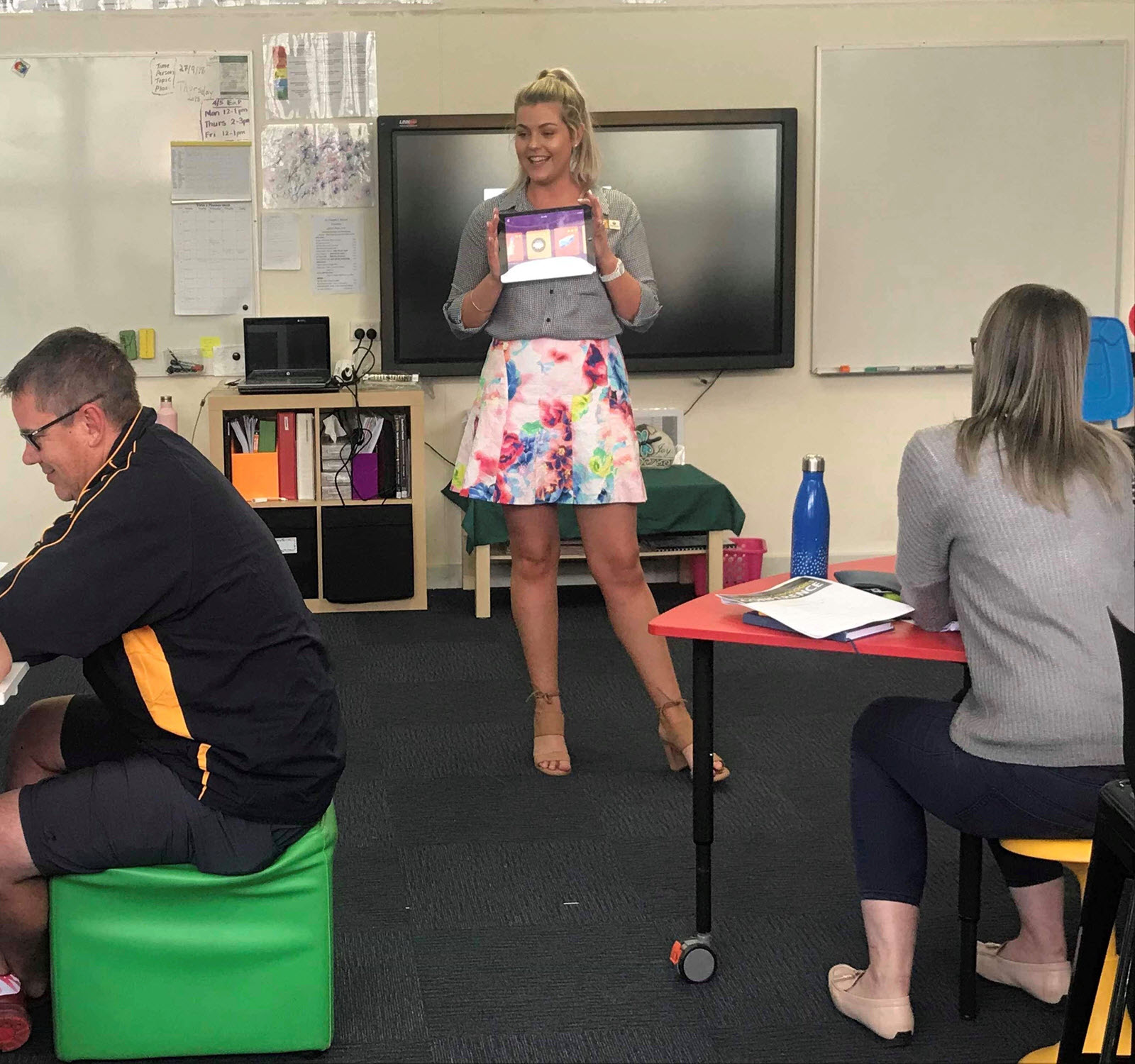 Conference leader presenting at front of classroom