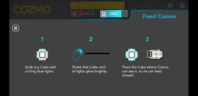 Image showing the steps to feed Cozmo the Robot. Step 1 is to grab any cube with circling blue lights. Step 2 is to shake that cube until all lights glow brightly. Step 3 is to place the cube where Cozmo can see it so he can feed himself.