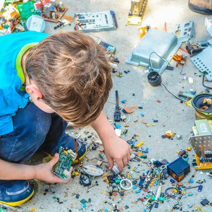 Photo of boy leaning over toys