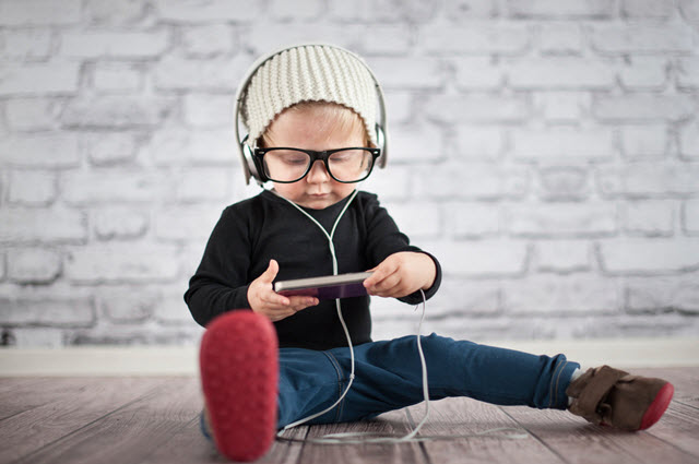 Image of child with headphones and mobile phone