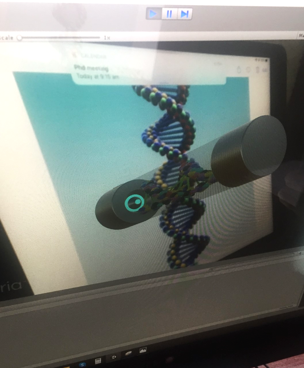 Photograph of a 3D model that is appearing on the computer.