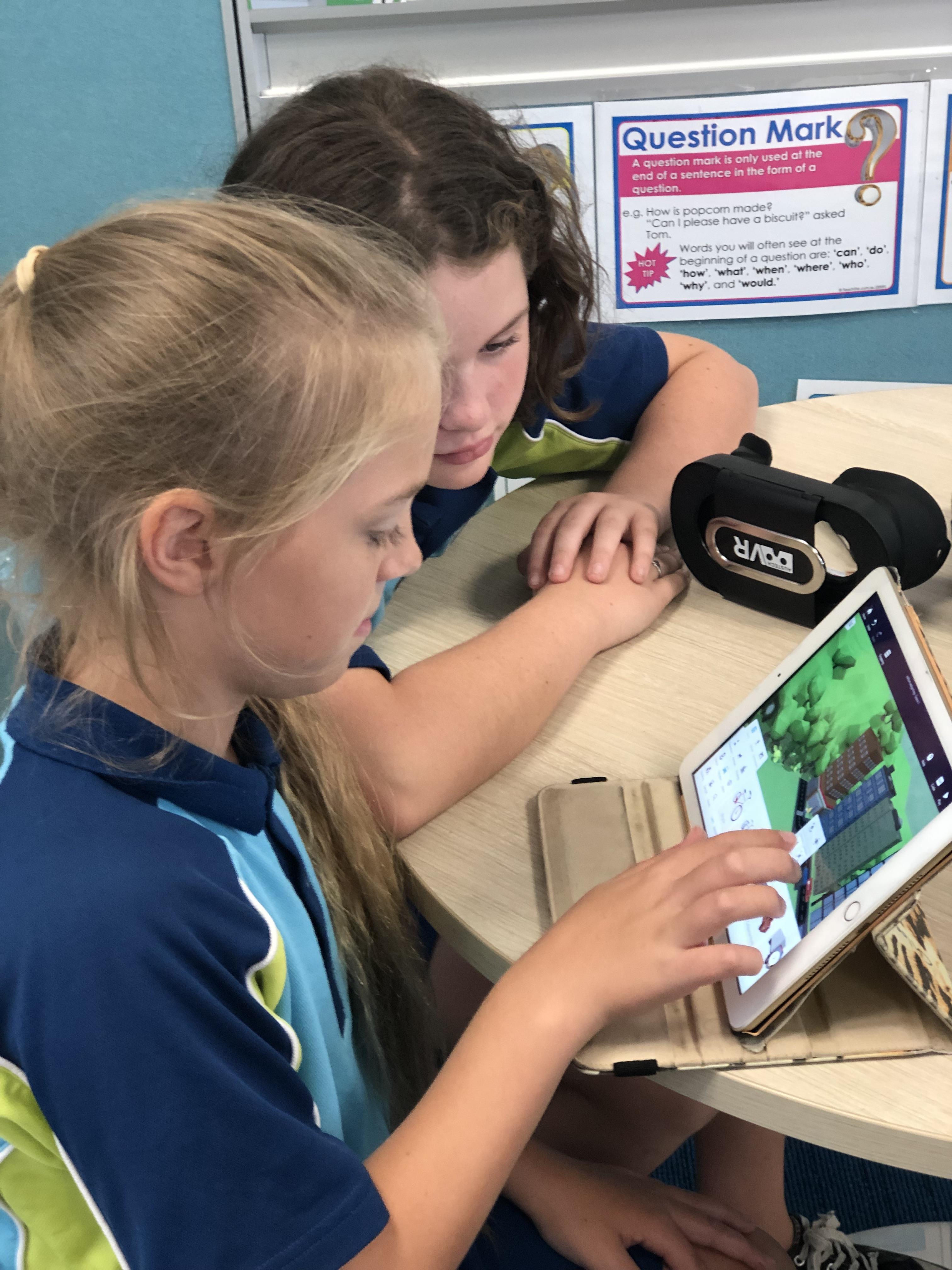 Two students looking at an ipad