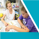 Teacher and student working at table