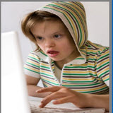 Girl with Down Syndrome looking at laptop