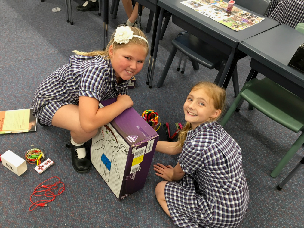 Photo of two primary school girls playing in a Makerspace.
