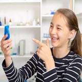 Image of girl pointing to gadget in her hand