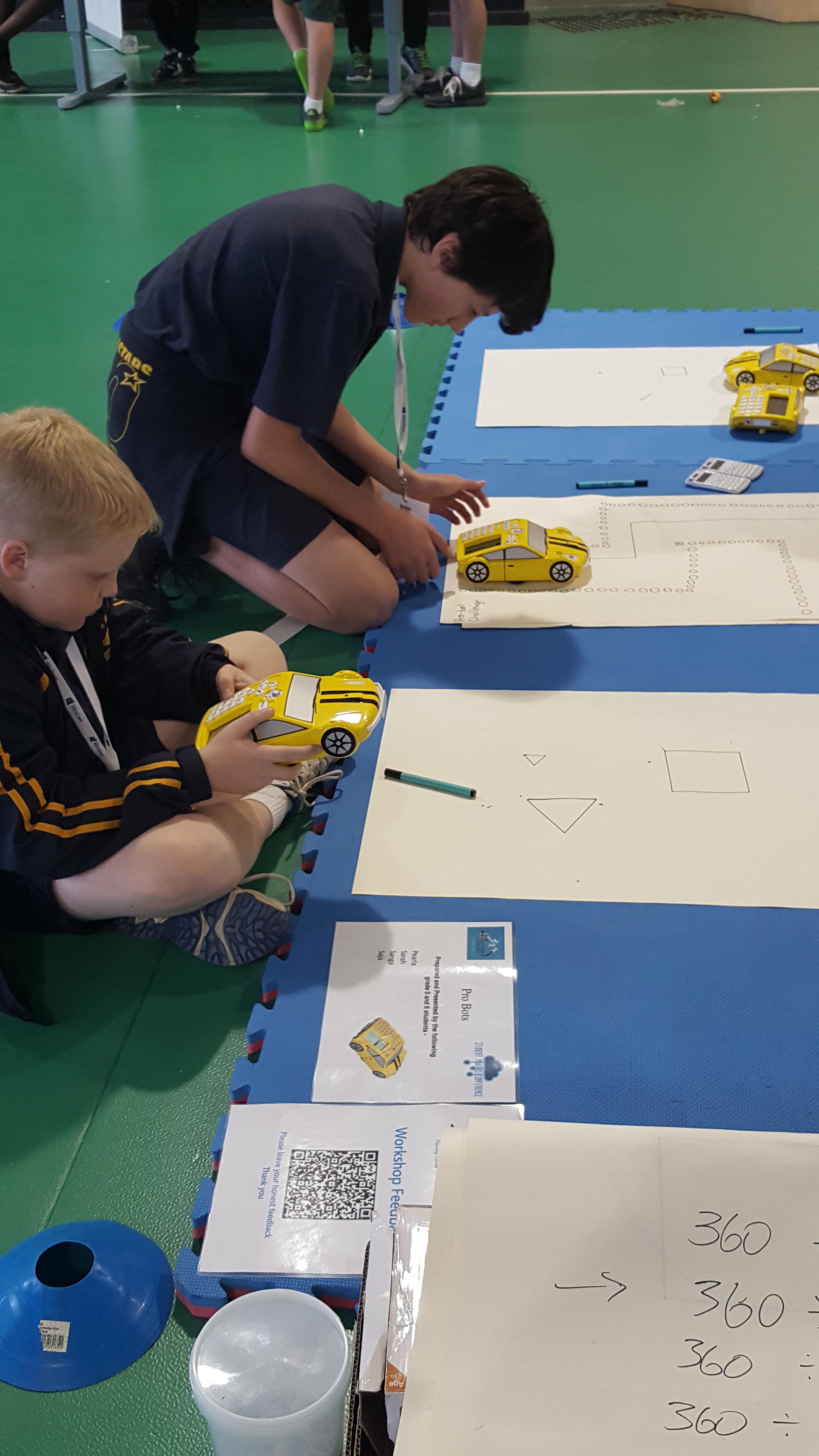Image of students with toy cars