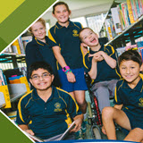Five school children in green and yellow uniform